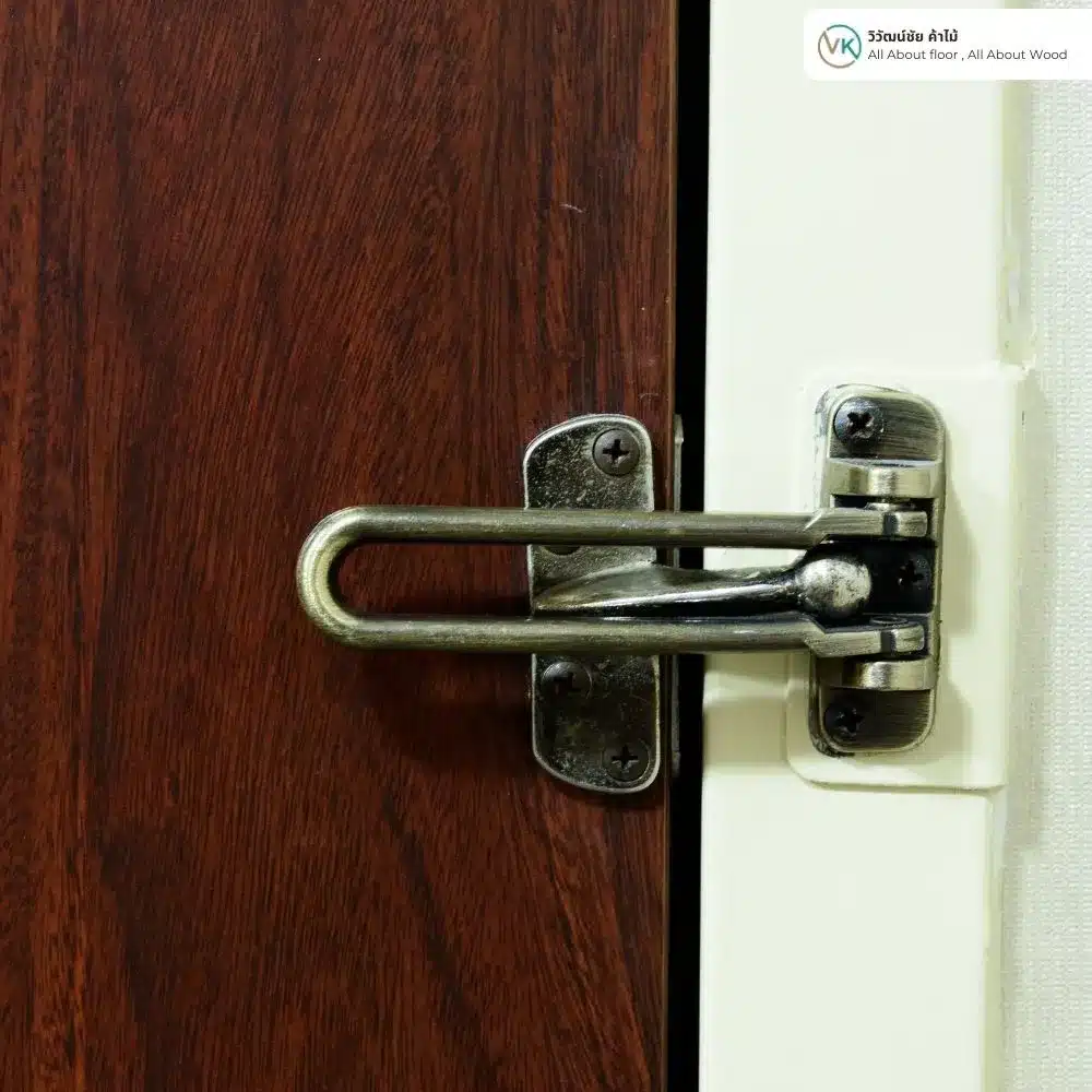 Swing Bar Latch Close-Up on Wood Door_result Satin swing bar latch installed on a white door frame